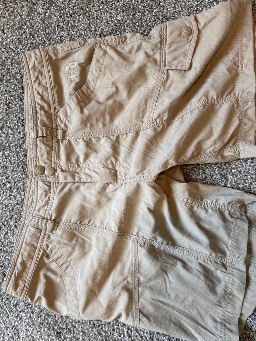 The North Face khaki shorts with red logo tab